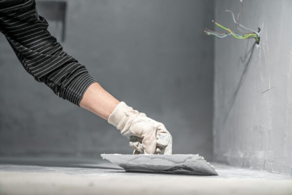 manual application of waterproofing on the floor on the construction site